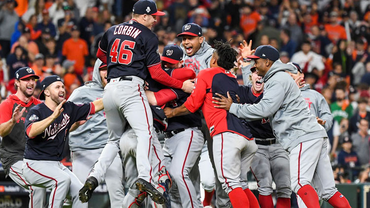 Baseball team jumping in huddle