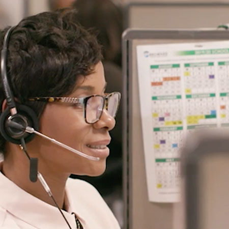 Employee with headset at computer
