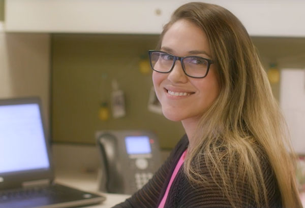 Smiling female employee looking at camera