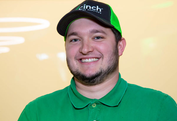 Smiling employee in brand hat