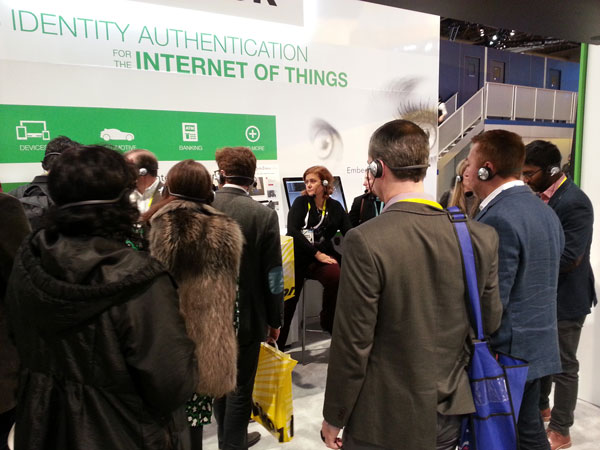 Tradeshow booth visitors watching presentation